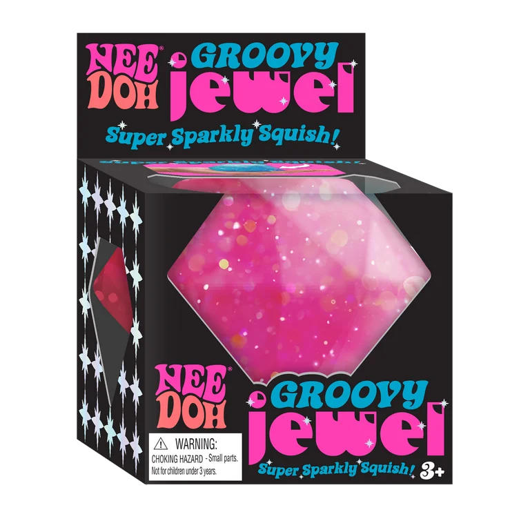 Bright pink glittery squishy jewel toy in black packaging labeled Nee Doh Groovy Jewel for kids ages three and up