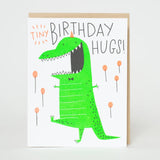 Tiny Birthday Hugs Dino Card featuring a cheerful green dinosaur and playful lettering, letter-pressed in the USA by Egg Press.