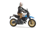 Scrambler Ducati Desert Sled & Driver toy with detailed rider, off-road tires, and blue motorcycle body in 1:16 scale.