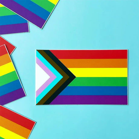 Progress Pride Flag Sticker showing vibrant colors and chevron design on a 3" x 1.8" vinyl sticker for laptops or bottles.
