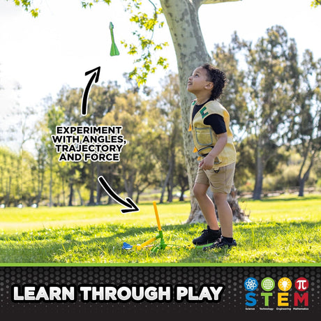 Child playing outdoors launching a rocket toy with adjustable stand under a sunny tree in a park setting