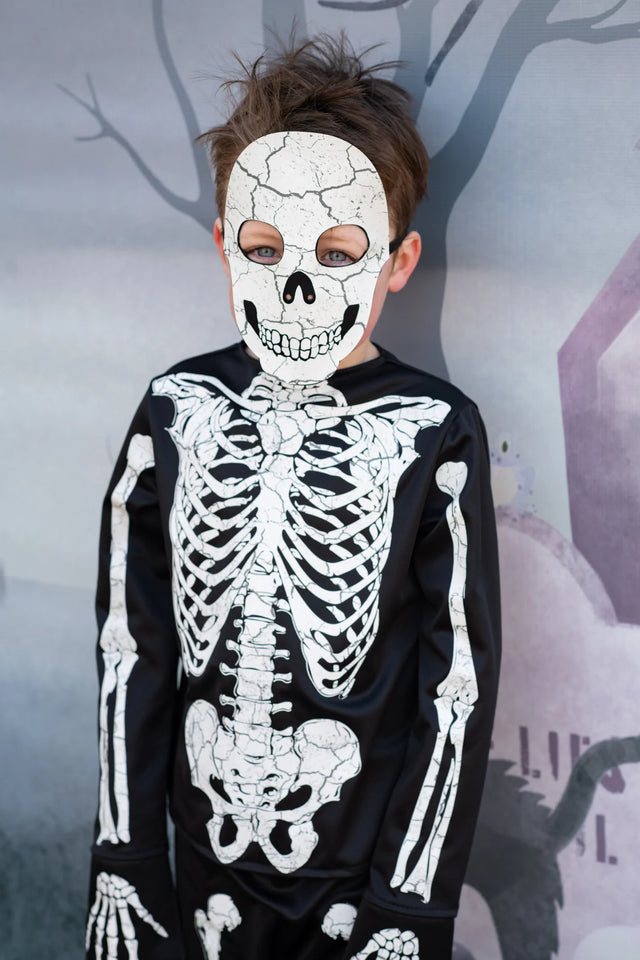 Child wearing Skeleton Outfit | Size 5-6 with detailed skeleton print and matching skull mask against a Halloween backdrop.