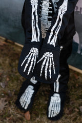 Skeleton Outfit | Size 5-6 showing black sleeves and pants with white skeleton bone prints on gloves and feet.