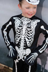 Child wearing the Skeleton Outfit | Size 5-6 with glow-in-the-dark skeleton design on shirt, pants, and mask.
