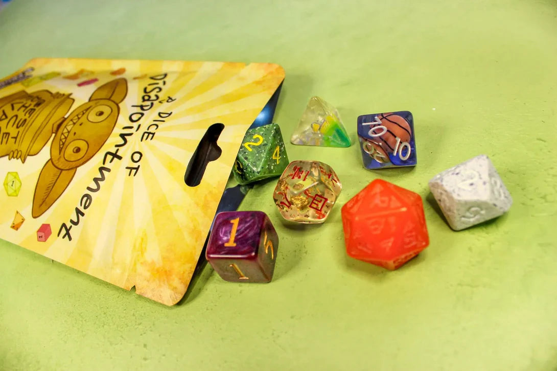 Dice of Disappointment Bag showing a mixed set of quirky, mismatched acrylic DND dice in various colors and styles.