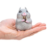 Chonky Cheeks Hamster squishy toy held in hand, gray hamster nibbling on a snack, about 3 inches tall.