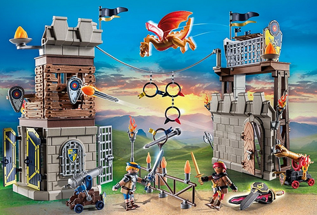 Novelmore | Tournament Arena playset with knights, cannons, targets, trap doors, and a flying dragon at sunset background.