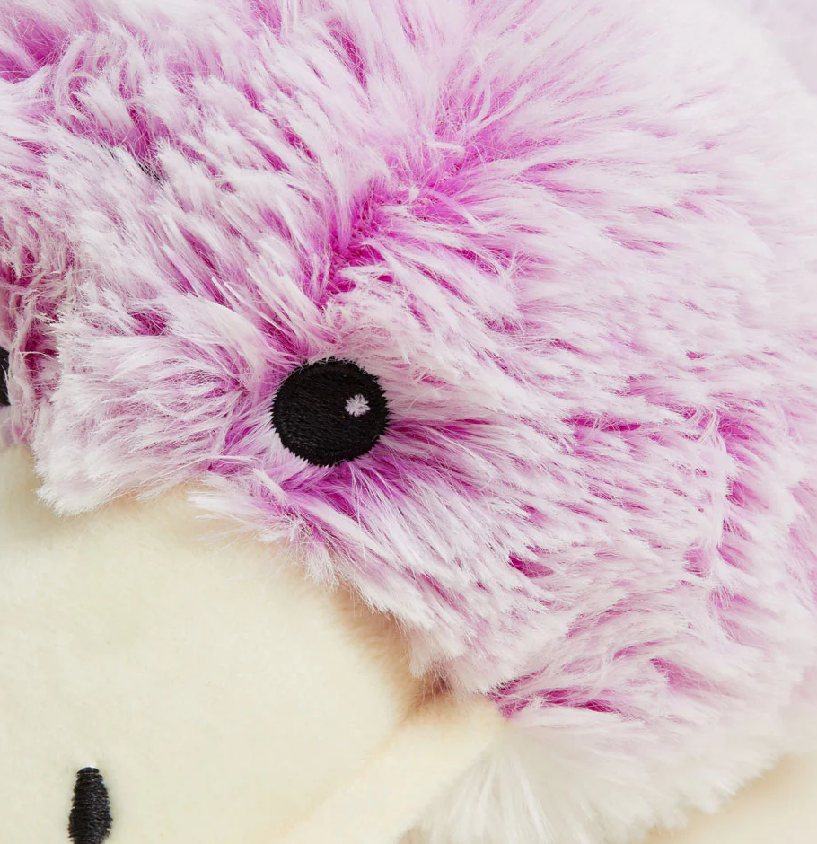 Close-up of Warmies | Platypus plush with soft purple and cream fur and black embroidered eye.