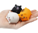 Little Cat 2 inch cat figurines in black, white, and orange held in a hand, cute assorted styles from Japan.