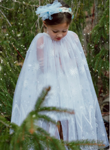 Winter Wonderland Cape | Size 3-4 featuring white tulle with delicate icy printed designs, worn by a child outdoors.