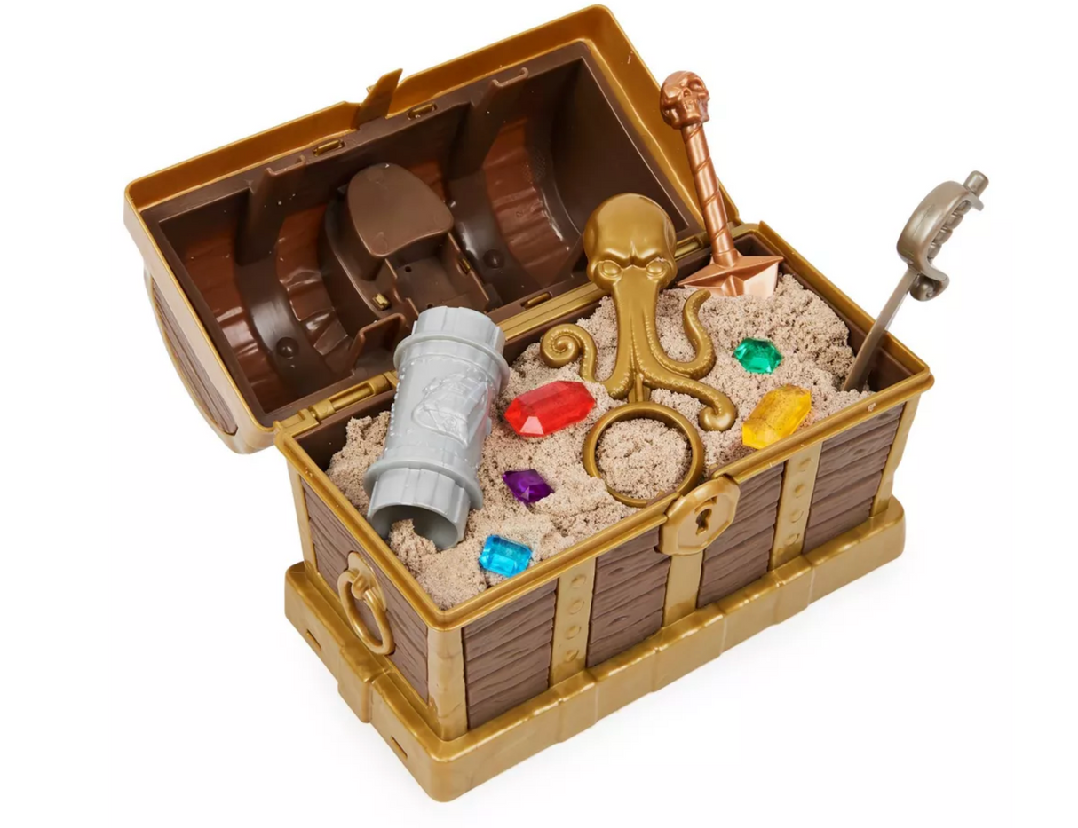 Kinetic Sand Treasure Hunt showing treasure chest with kinetic sand, colorful gems, and pirate-themed tools inside.