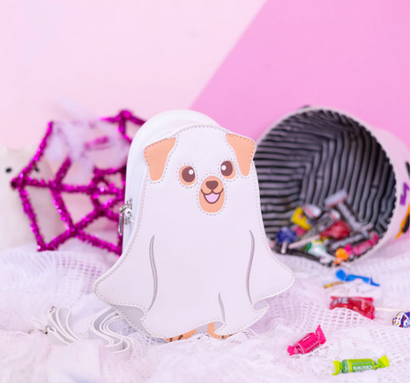 Ghost Dog Glow in the Dark Handbag shaped like a cute ghost pup with Halloween candy and decor background.