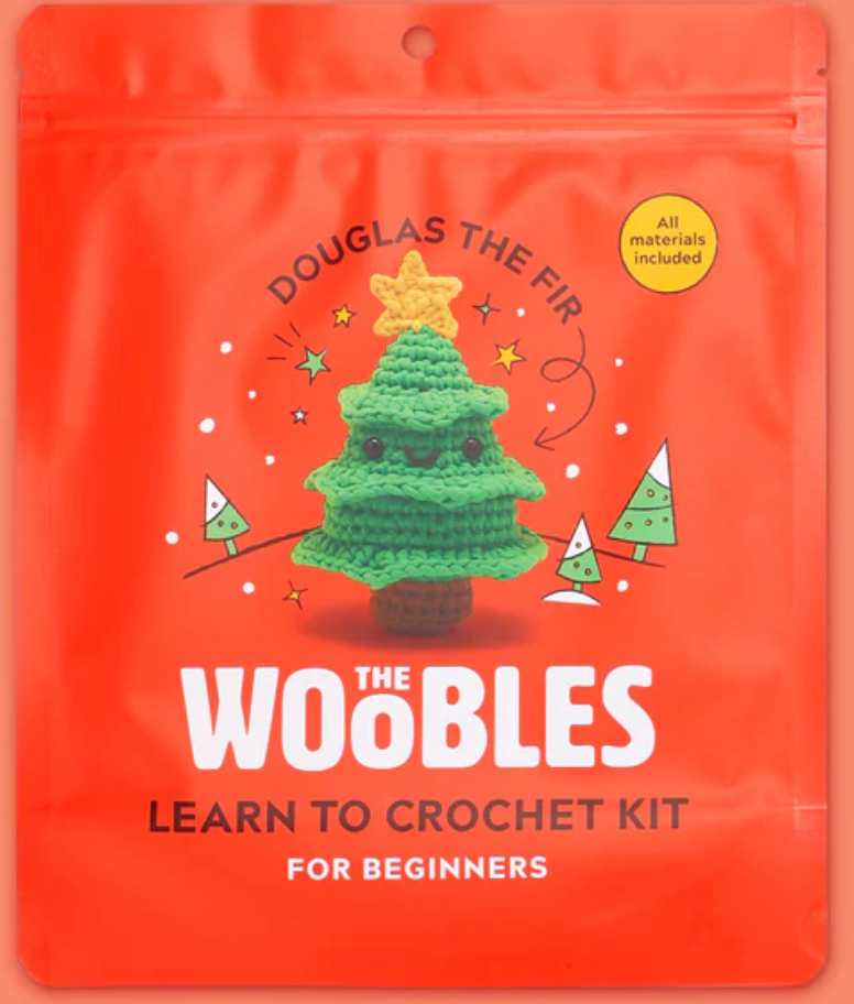 Bright orange package featuring Douglas the Fir crochet tree with star, eyes, and smiling face for beginner kit