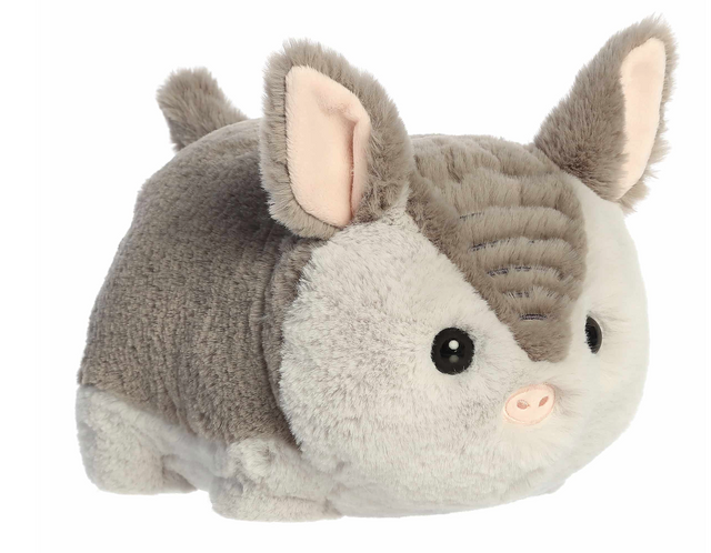 Soft plush toy resembling a cute armadillo with large ears and a rounded, huggable body.