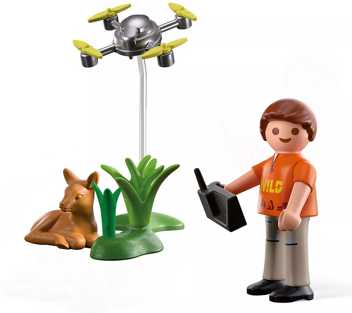 Play figure flying a drone near a resting fawn and green plants in a forest rescue adventure set.