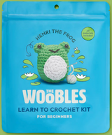 Blue package featuring Henri the Frog crochet kit with a green frog and yarn ball illustration for beginners.