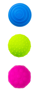 Three vibrant textured bath shaker balls in blue, yellow, and pink for sensory play during tub time.