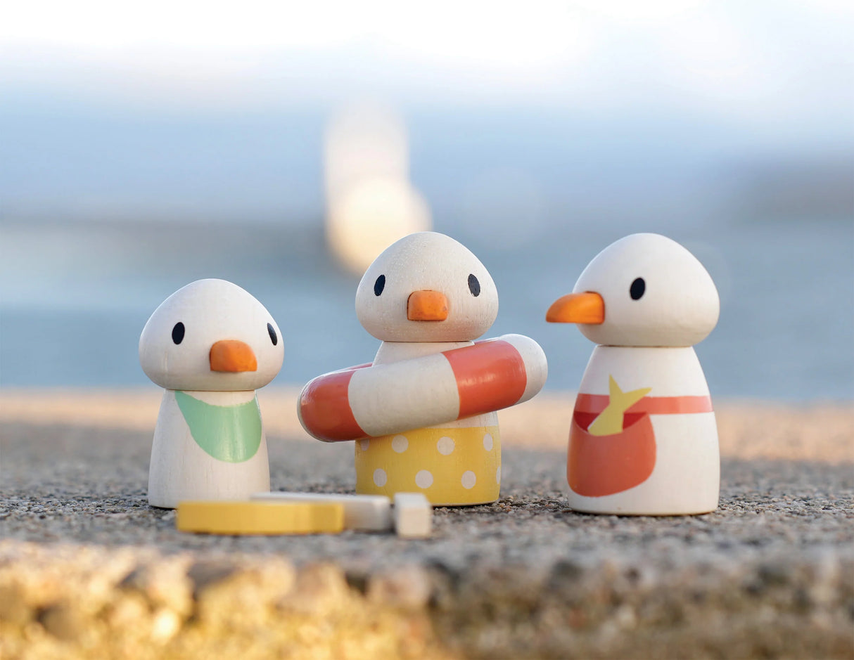 Sandy's Beach Hut wooden toy seagull family with life ring and accessories on sandy beach for imaginative play.