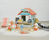 Sandy's Beach Hut wooden toy set with seagulls, fish and chips stall, deck chair, and seaside accessories for imaginative play.