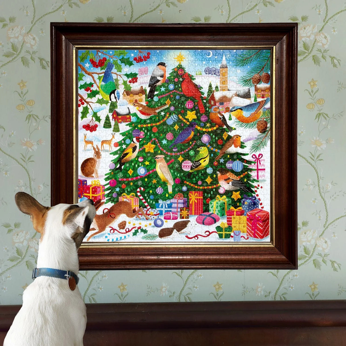 Dog looking at a framed puzzle of a Christmas tree decorated with colorful songbirds and festive ornaments