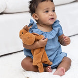 Baby holding the Teether Buddy | Max the Moose plush toy with teething rings and soft faux fur.