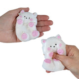 Taba-licious Cuties Squishy held in hands, soft white and pink bear-shaped stress-relief toy being squeezed