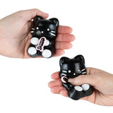 Taba-licious Cuties Squishy black cat toy held and squeezed showing its soft, stress-relief texture and cute design.