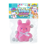 Taba-licious Cuties Squishy pink bunny with white paws and bow in clear packaging for stress relief and fun.