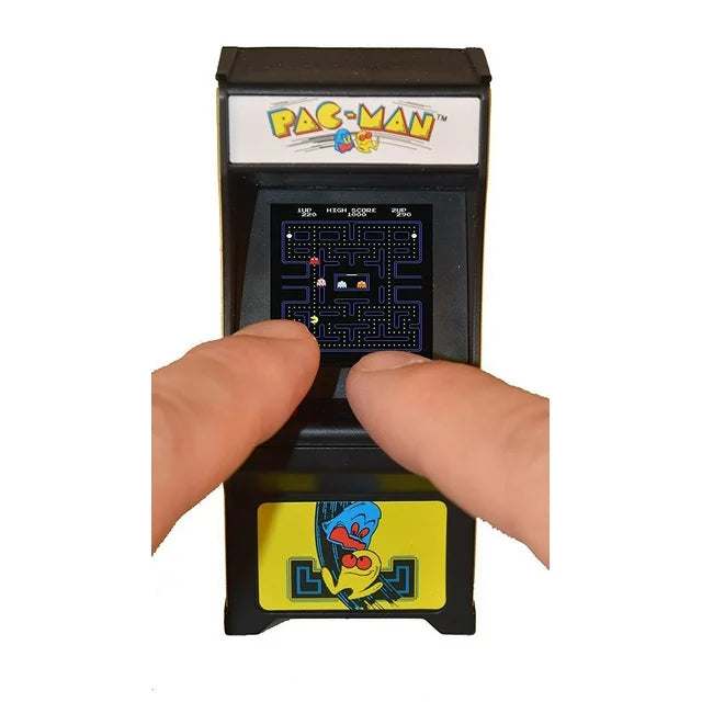 Tiny Arcade Pacman handheld arcade game with joystick controlled by fingers, playing classic Pac-Man maze game.