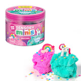 Pink and teal cloud clay with unicorn and rainbow toys beside a closed pink sensory mini jar container