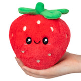 Soft and cuddly Strawberry Snackers plush toy with a friendly smile and bright green leaves held in hand