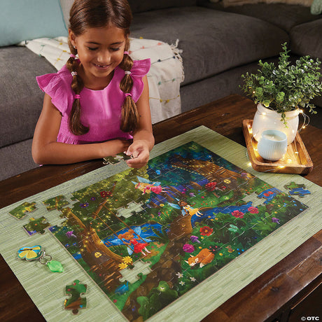 Young girl assembling PZ 100pc Seek&Find Fairies puzzle featuring a colorful forest scene with hidden glow-in-the-dark items.