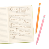 Noted Extra Thick Graphite Mechanical Pencils in orange and pink beside notebook with scientific method notes.