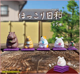Tea Time Animal Blind Box featuring five cute animals sipping tea on purple cushions in a charming outdoor setting.