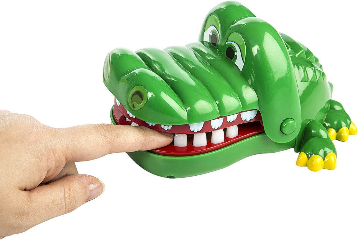 Crocodile Dentist game with a green crocodile toy snapping jaws as a finger presses its tooth toy.