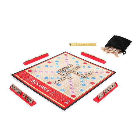 Scrabble board game with wooden tiles, racks, and drawstring bag set up for play with words on the board.