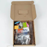 Open box showing Crafters Polymer Clay Jewelry kit with colorful clay blocks and earring and necklace forms inside.