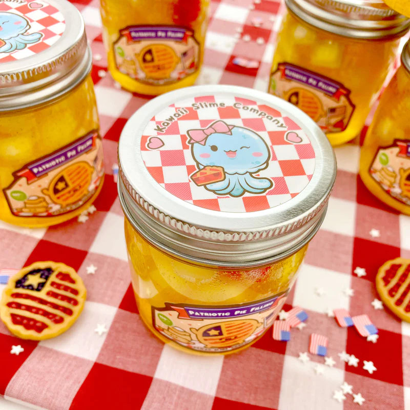Patriotic Pie Filling Jelly Cube Slime in jar with Americana-themed decorations on red and white checkered tablecloth