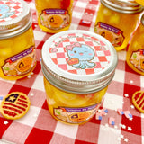 Patriotic Pie Filling Jelly Cube Slime in jar with Americana-themed decorations on red and white checkered tablecloth