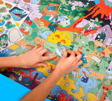 Dinosaur Giant Sticker Poster with colorful dinosaur scene and over 100 stickers being placed on the giant poster.