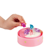 Hand placing colorful faux crystals onto clay in the Butterfly Fairy Lights crafting kit base.