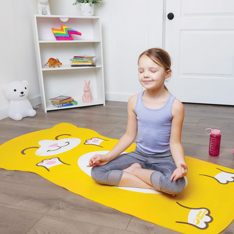 Child practicing meditation on a bright yellow Yoga Mat - Cat designed for kids, 65.5" x 31.5", age 3+