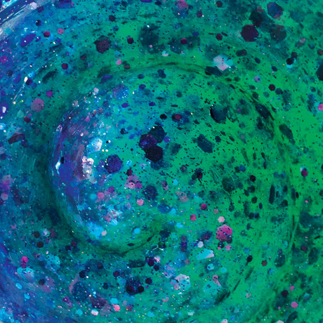 Close-up of Glowbrights Mermaid Tail Thinking Putty with shimmering purple and turquoise sparkles and sea green glow.