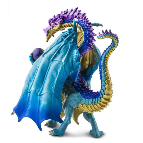 Wizard Dragon figure with blue and gold scales holding a metallic purple crystal ball, wings folded like a cloak.